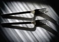 Black and white still life image with shiny chrome forks Royalty Free Stock Photo