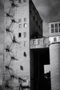 Black and white street photo. An old abandoned factory. The ugly architecture of old factories. Metal exterior stairs.