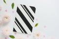 black and white striped notebook, pink plastic hearts and pink flowers of chrysanthemums and green leaves on a white table. Royalty Free Stock Photo