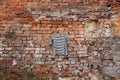 Black and white striped womens blouse hanging on a brick old wall outdoors