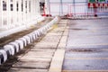 Black and white stripes edge of the footpath. Space for parking motorcycles. Parking slope. The drain line has a lid.