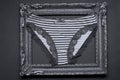 Black and white stripes panties in a wooden photo frame Royalty Free Stock Photo