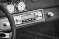 Black and white  Styled Image Of An Old Car Radio and Vintage Porsche steering wheel Royalty Free Stock Photo