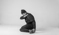 Black and white stylish modern epic portrait of bboy on a white background. Breakdance and hiphop dancer. Mysterious and