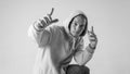 Black and white stylish modern epic portrait of bboy in a white hoodie on a white background. Breakdance and hiphop