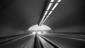 Black and white subway escalators in deep perspective Royalty Free Stock Photo