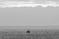 Black And White Sunset With A Beautiful Sky And A Fishing Boat Appearing In The Photo On Las Americas Beach. April 11, 2019. Santa Royalty Free Stock Photo