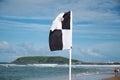 Black and white surf craft flag flying on patrolled beach at Coffs Harbour