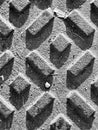 black and white surface texture of a manhole grate Royalty Free Stock Photo