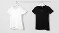 Black and white t-shirts hanging on hangers. Royalty Free Stock Photo
