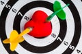 Black white target with two darts in heart love symbol as bullseye Royalty Free Stock Photo