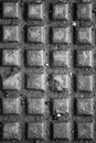 Black and white texture of metal plate with embossed square patterns Royalty Free Stock Photo