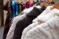 Black and white thick knitted wool winter jumpers and jackets for sale on a marlet stall