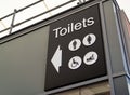 Black and white toilets sign with men, ladies, disabled and baby changing icons.