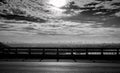 Black and white toned view from the bridge of city near the river and sky and white clouds. Sad, hopeless and death background. Royalty Free Stock Photo
