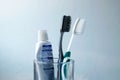 Black and white Toothbrush and toothpaste in glass