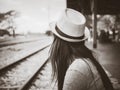Black and white traveler woman waits train on the railway