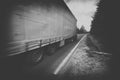 Black and white truck speeding on country highway