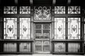 black and white tudor mansion door with ironwork