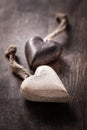 Black and white: two wooden hearts on brown background Royalty Free Stock Photo