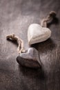 Black and white: two wooden hearts on brown background Royalty Free Stock Photo