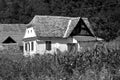 Black and white. Typical rural peasant houses in the village Alma Vii Almen Transylvania, Romania. Royalty Free Stock Photo