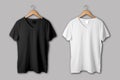 Black and white V-Neck Shirt Mock-up on wooden hanger, front view. Royalty Free Stock Photo