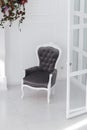 Black and white velours vintage armchair in minimalistic scandinavian room. vertical photo with clear space for text