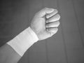 Black and white version of athlete sprained wrist taped up with a wrist tape job