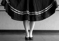 Black and white version of character ballet parallel position with skirt held Royalty Free Stock Photo