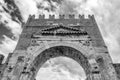 Black and white view of the Arch of Augustus in Rimini, Italy, the oldest extant Roman arch, against a dramatic sky Royalty Free Stock Photo