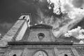 Black and white view of the bell tower and part of the facade of the Santa Croce church in the historic center of Vinci, Florence