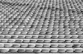 Black and white view of endless rows of empty chairs in a stadium