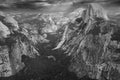 A black and white view of the majestic Half Dome and the valley below from a viewpoint on the Glacier Point Hike trial.