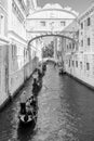 Black and white view of a row of gondolas under the famous Ponte dei Sospiri, Bridge of Sighs in Venice, Italy Royalty Free Stock Photo