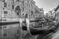 Black and white view of Typical gondolas parked in a Venetian canal, Venice, Italy Royalty Free Stock Photo