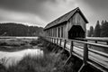 black and white vintage-style covered bridge Royalty Free Stock Photo