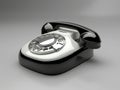 Black and white vintage telephone with a white dial displayed on a neutral background Royalty Free Stock Photo