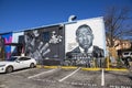 A black and white wall mural of MF Doom and John Lewis on the side of a brick building in Little Five Points