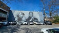 a black and white wall mural of the rap group OutKast with Big Boi and Andre 3000 with parked cars in Atlanta Georgia