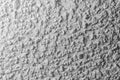 Black and white whitewashed concrete wall interspersed with stones Royalty Free Stock Photo