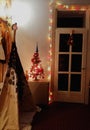 Black and white wigwam teepee kids tent standing in the living room with christmas tree and white glassy door.