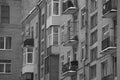 Black and white windows and balconies of a brick house