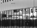 Black and white windows with houses in the reflection. Office or school building.