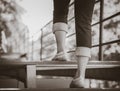 Black and white woman is stepping up a staircase Royalty Free Stock Photo