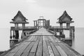 Black and white, wooden bridge leading to unfinished temple building