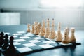 Black and white wooden chess set before the game on the chessboard. Light falls from the window Royalty Free Stock Photo