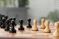 Black and white wooden pawns on chess board, closeup. Space for text Royalty Free Stock Photo