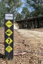 Black, white and yellow Road Subject To Flooding warning sign on Royalty Free Stock Photo