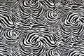 Black and white zebra skin pattered material creates an optical illusion. Royalty Free Stock Photo